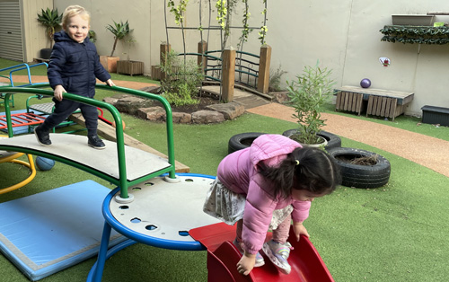 Two 3-year-old children at kinder in the playground