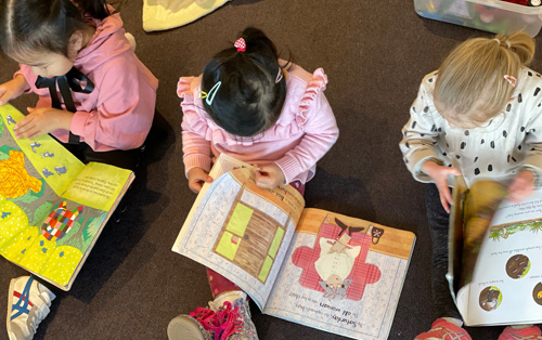 children sitting reading books