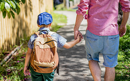 Father walking his child to child care